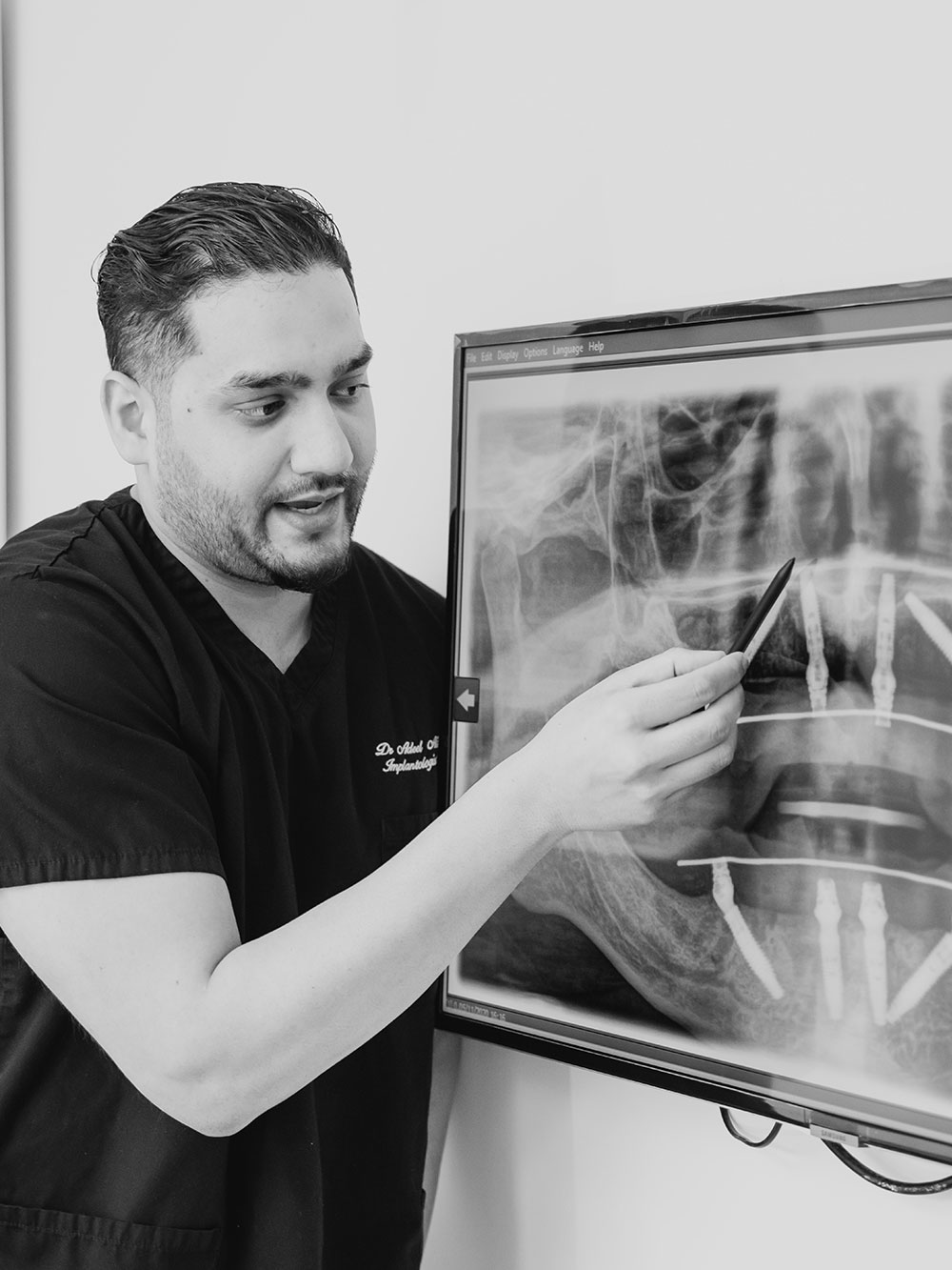 Dr Ali examining patient dental x-ray